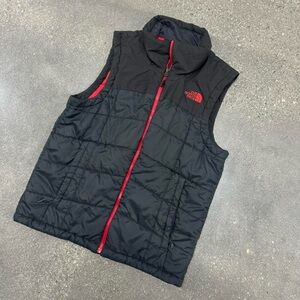 The North Face black men’s puffer vest with red accents size medium